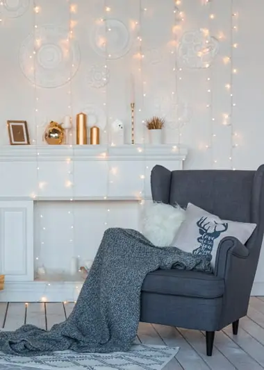 christmas pillows next to a fireplace