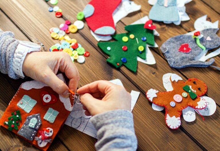 creative ideas personalized stockings feature - woman's hands stitching a felt stocking decoration